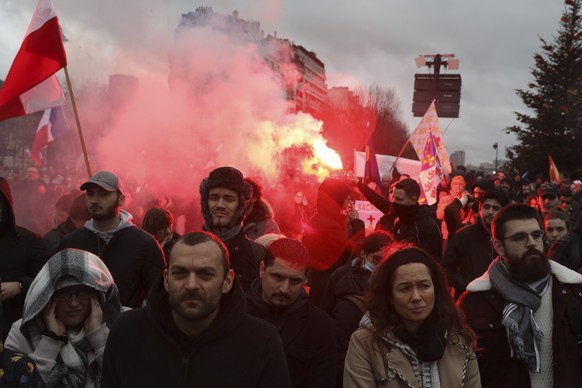Demonstrators, in opposition to vaccine pass and vaccinations to protect against COVID-19 gather during a rally in Paris, France, Saturday, Jan. 8, 2022. President Emmanuel Macron has publicly berated ...