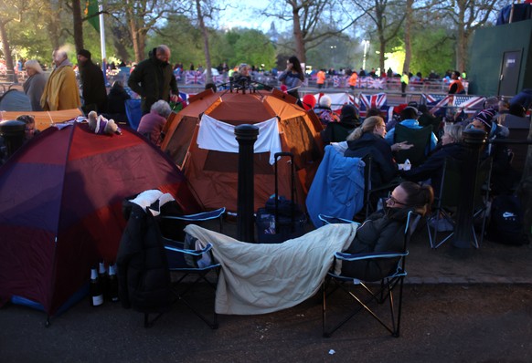 epa10611419 Royal fans wait on the coronation procession route on The Mall before the coronation ceremony for Britain&#039;s King Charles III and the Queen Consort Camilla, in London, Britain, 06 May  ...