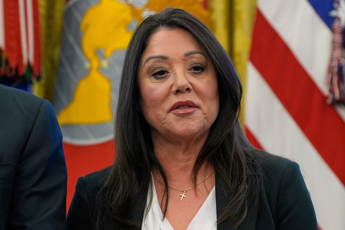 FILE - Labor Secretary Lori Chavez-DeRemer listens as President Donald Trump speaks with reporters while signing executive orders in the Oval Office of the White House, April 23, 2025, in Washington.  ...