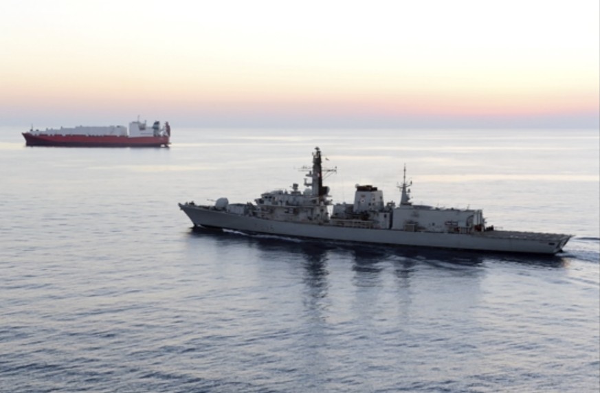 In this image from file video provided by UK Ministry of Defence, British navy vessel HMS Montrose escorts another ship during a mission to remove chemical weapons from Syria at sea off coast of Cypru ...