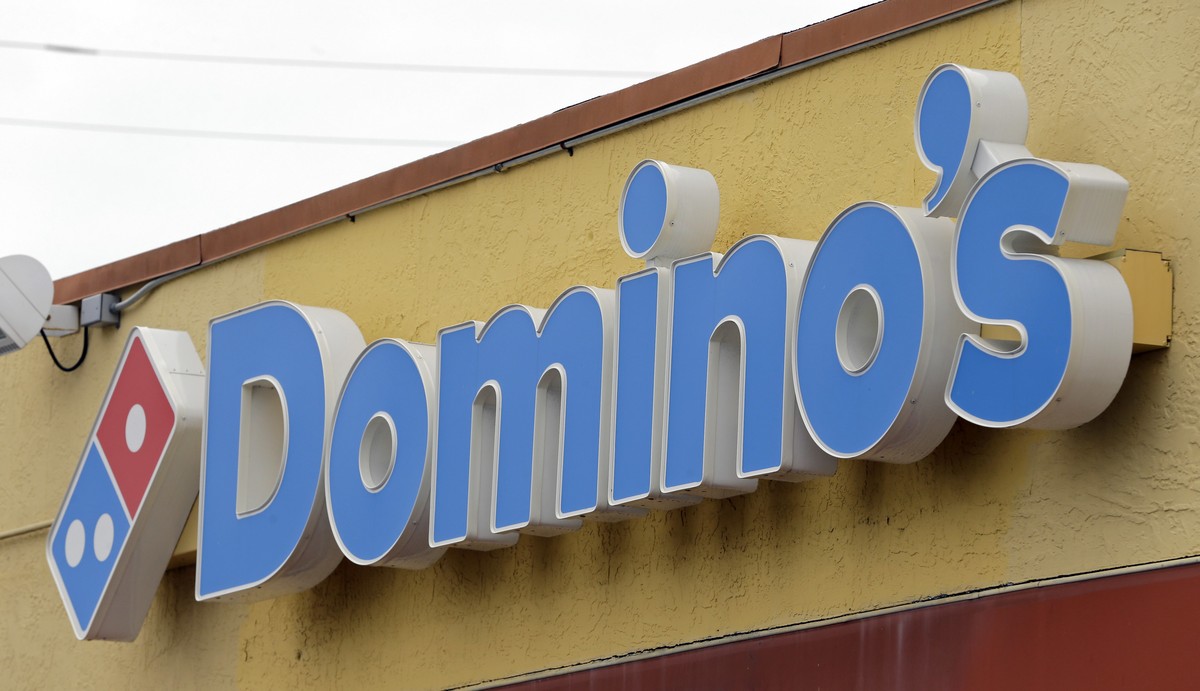 FILE - This Thursday, Oct. 27, 2016, photo shows a Domino's Pizza sign at a location in Hialeah, Fla. Domino's Pizza Inc. on Thursday, Feb. 21, 2019 reported fourth-quarter earnings of $111. ...