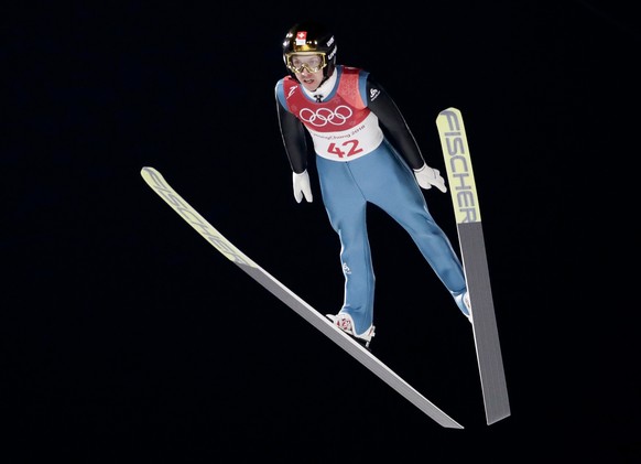 Simon Ammann, of Switzerland, soars through the air during the men's normal hill individual ski jumping qualifier ahead of the 2018 Winter Olympics in Pyeongchang, South Korea, Thursday, Feb. 8, 2018. (AP Photo/Matthias Schrader)