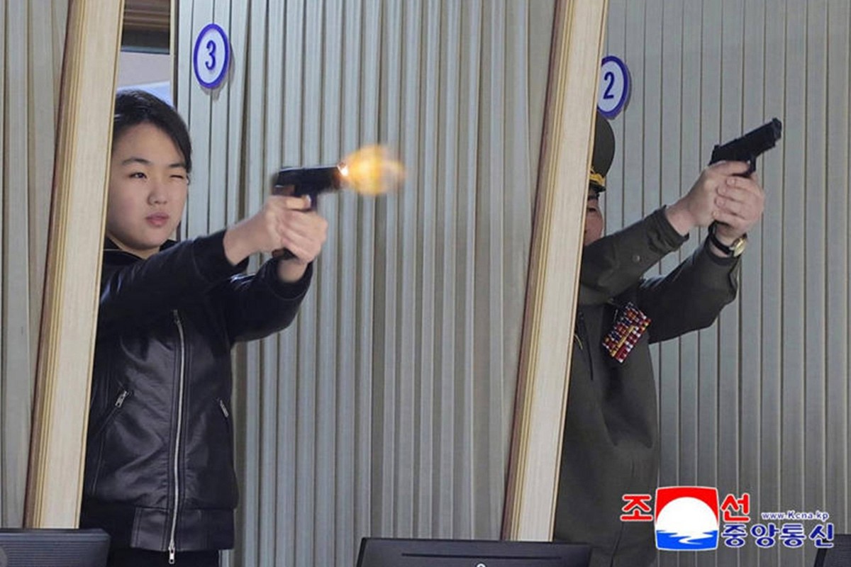 This image, released on March 12, 2026, by the North Korean Official News Service KCNA, shows North Korean leader Kim Jong Un and his daughter, Kim Ju Ae, visiting a munitions factory. The father-daug ...
