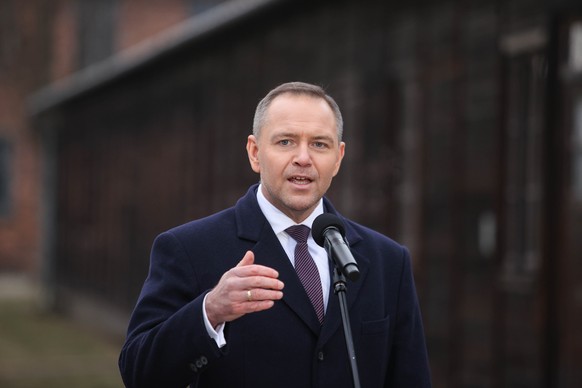 epa12685245 Polish President Karol Nawrocki speaks during a wreath-laying ceremony at the Death Wall on the site of the former Auschwitz concentration camp in Oswiecim, Poland, 27 January 2026. The bi ...