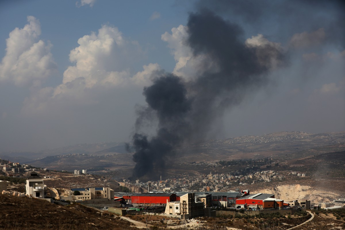 epa10954295 Smoke rises above the town of Deir Sharaf after Israeli settlers attacked the village and set Palestinan cars and shops on fire, near the West Bank city of Nablus, 02 November 2023. The Pa ...