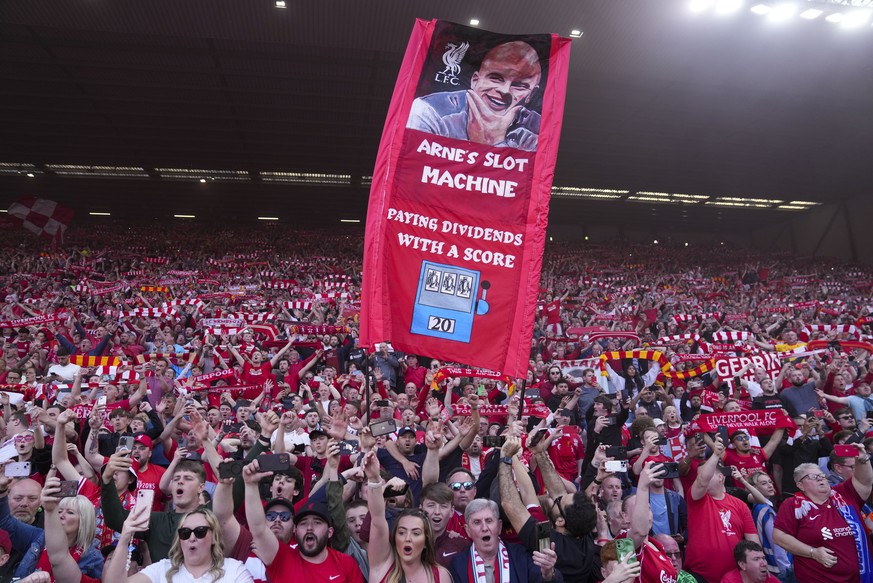 Liverpool supporters celebrate after their team won the English Premier League soccer match between Liverpool and Tottenham Hotspur and clinched the Premier League title at Anfield in Liverpool, Engla ...