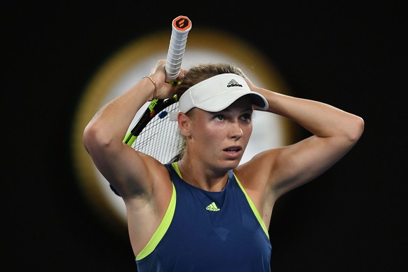 epa06467891 Caroline Wozniacki of Denmark adjusts her hair during a women&#039;s quarter final match against Carla Suarez Navarro of Spain at the Australian Open tennis tournament, in Melbourne, Victo ...