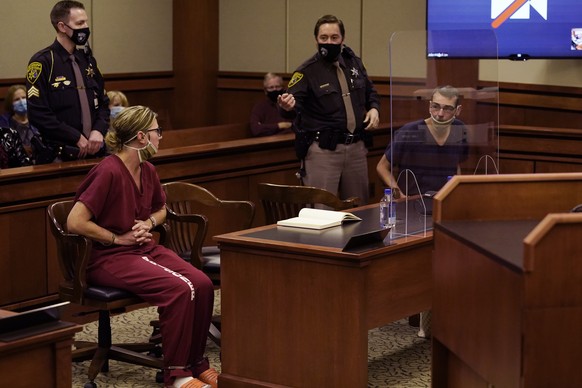 James Crumbley, right, looks towards his wife Jennifer Crumbley during a hearing in Rochester Hills, Mich., Tuesday, Dec. 14, 2021. The parents of accused Oxford High School shooter Ethan Crumbley on  ...