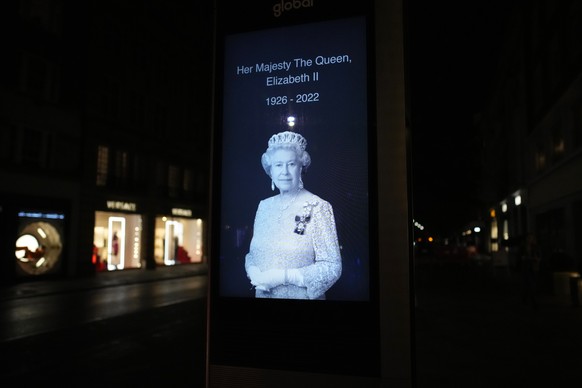 A picture of Britain's Queen Elizabeth II is set up in a London street, Thursday, Sept. 8, 2022, after her death was announced. Queen Elizabeth II, Britain's longest-reigning monarch and a r ...