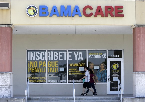 In this Thursday, May 11, 2017, photo, people walk by Sunshine Life &amp; Health Advisors, in Hialeah, Fla. The latest Republican push to replace the Obama-era health care law would shift funding and  ...