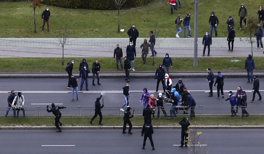 People clash with policemen during an opposition rally to protest the official presidential election results in Minsk, Belarus, Sunday, Oct. 11, 2020. Hundreds of thousands of Belarusians have been pr ...