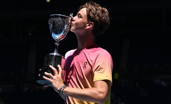 epa11850776 Henry Bernet of Switzerland kisses the winners trophy following his Junior Boys Singles final win over Benjamin Willwerth of the USA during the 2025 Australian Open at Melbourne Park in Me ...
