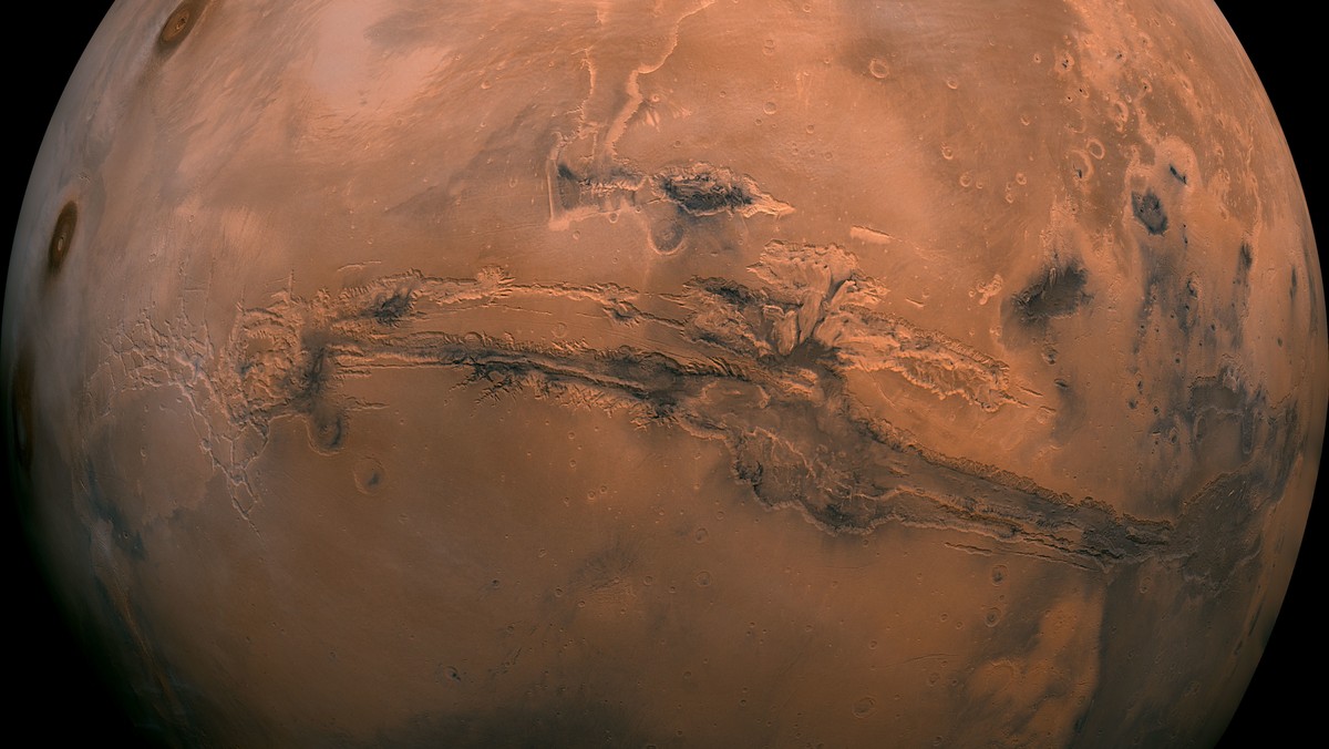 FILE - This image made available by NASA shows the planet Mars. This composite photo was created from over 100 images of Mars taken by Viking Orbiters in the 1970s. On Tuesday, July 31, 2018, the red  ...