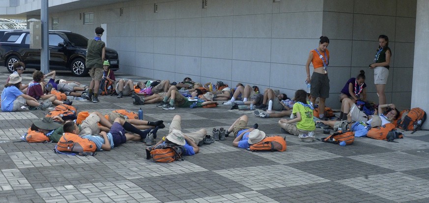 Attendees of the World Scout Jamboree lie down to rest at a scout camping site in Buan, South Korea, Friday, Aug. 4, 2023. More than 4,000 British Scouts will leave the World Scout Jamboree at a camps ...