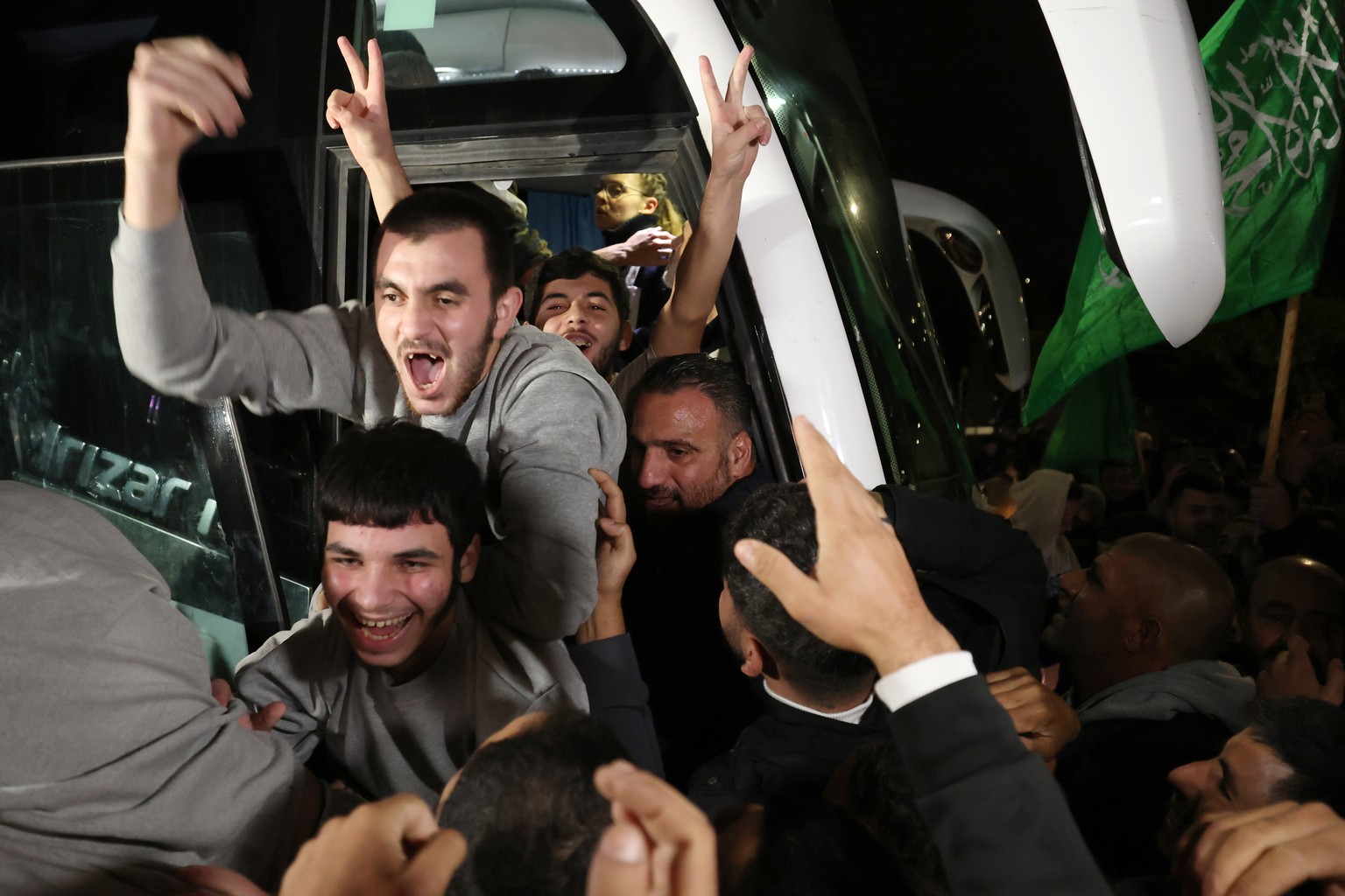 epa10998447 Palestinian prisoners freed from the Ofer Israeli military prison react as they get greeted by crowds awaiting their return in Beitonia, near Ramallah, West Bank, 28 November 2023. Israel  ...