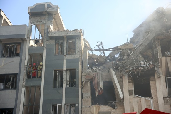 epa12172796 Fire fighters work in building that was hit by Israeli air strikes in central Tehran, Iran, 13 June 2025. Israel confirms it has launched strikes on Iran&#039;s &#039;nuclear program&#039; ...
