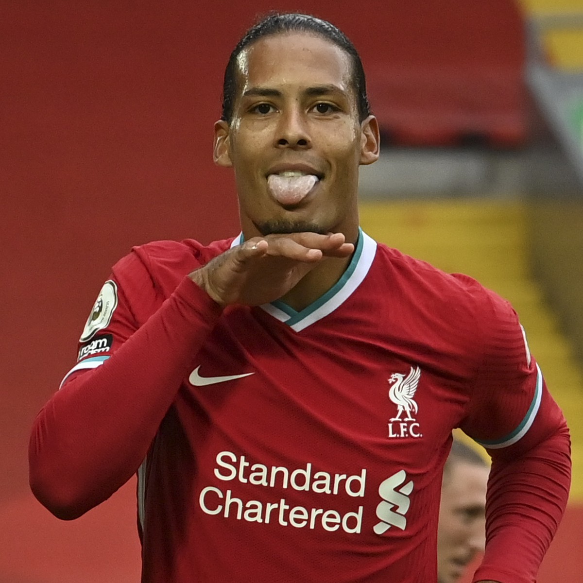 Liverpool's Virgil van Dijk, left, celebrates after he scored his side's second goal during the English Premier League soccer match between Liverpool and Leeds United, at the Anfield stadium ...
