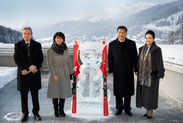 (L-R) Swiss President Doris Leuthard, her husband Roland Hausin, Chinese President Xi Jinping and his wife Peng Liyuan stand in front of a panda ice sculpture as they launch the Swiss-Sino year of tou ...