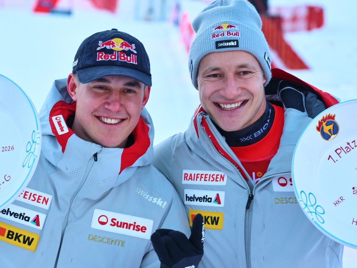 Winner Switzerland's Marco Odermatt, right, and fellow-countryman second placed Franjo von Allmen pose with their trophies of a men's World Cup super-G, in Kitzbuehel, Friday, Jan. 23, 2026. ...
