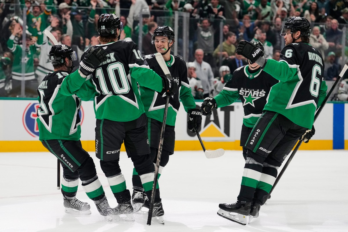 Dallas Stars' Colin Blackwell (15), Oskar Bäck (10), Wyatt Johnston, center rear, and Lian Bichsel (6) celebrate after Johnston scored against the Minnesota Wild in the first period of Game 2 of  ...