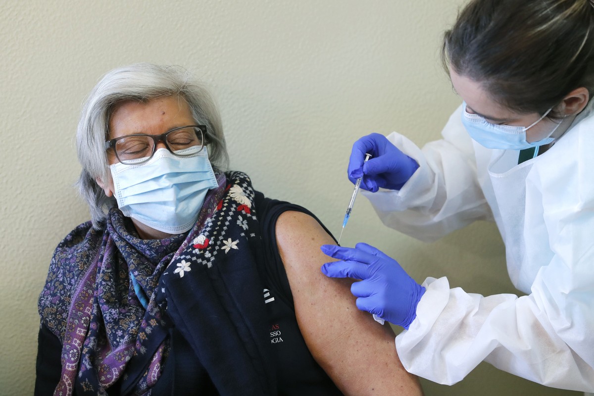 A doctor receives a dose of the Pfizer-BioNTech COVID-19 vaccine at the Santa Maria hospital in Lisbon, Sunday, Dec. 27, 2020. Portugal started its vaccination program on Sunday with medical personnel ...