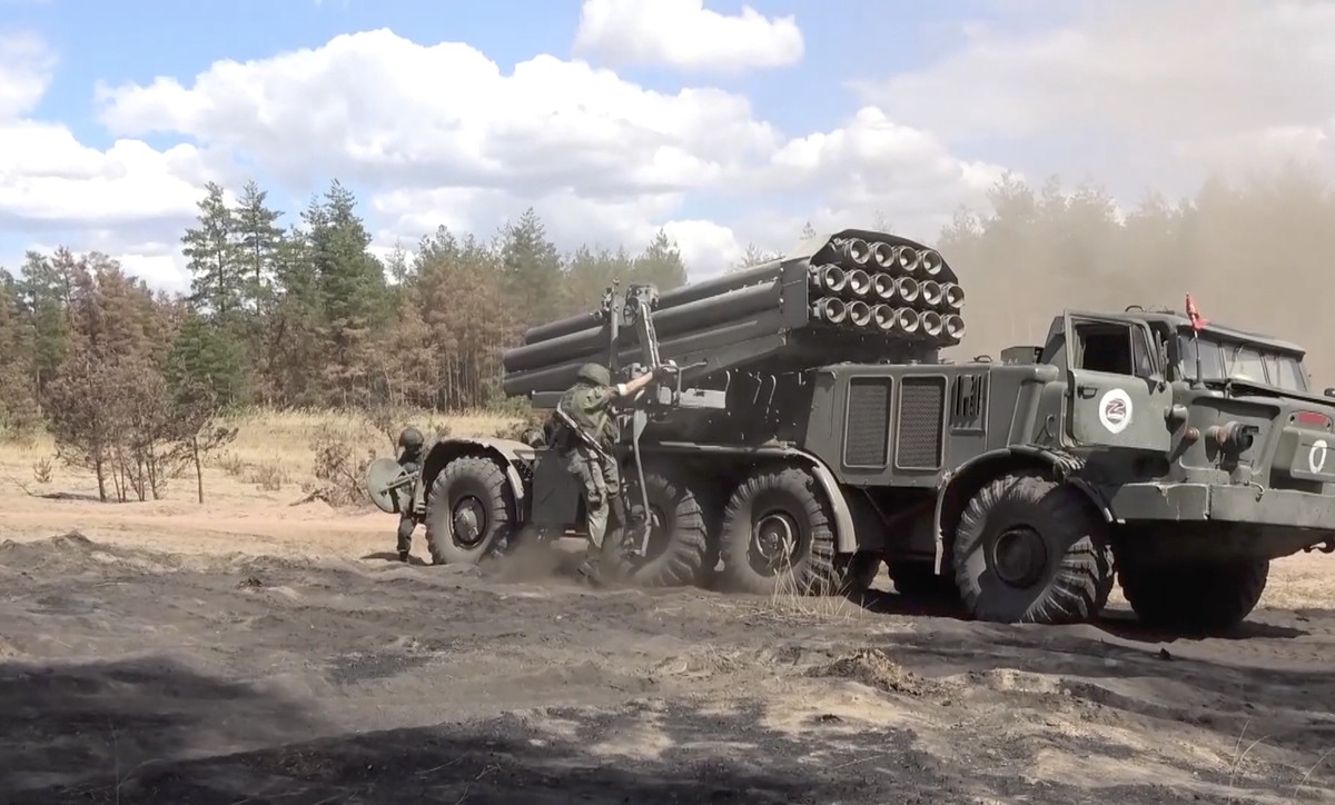 epa10083851 A handout still image taken from handout video provided by the Russian Defence ministry press-service shows Russian servicemen preparing a Russian multiple launch rocket systems ?Hurricane ...