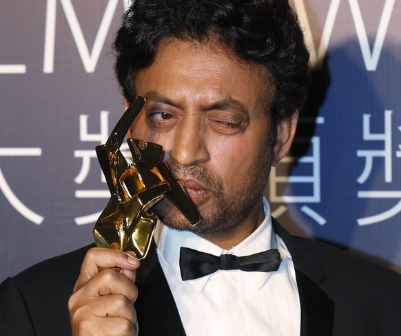 Indian actor Irrfan Khan celebrates after winning the Best Actor for his movie &quot;The Lunchbox&quot; of the Asian Film Awards in Macau Thursday, March 27, 2014. (AP Photo/Kin Cheung)