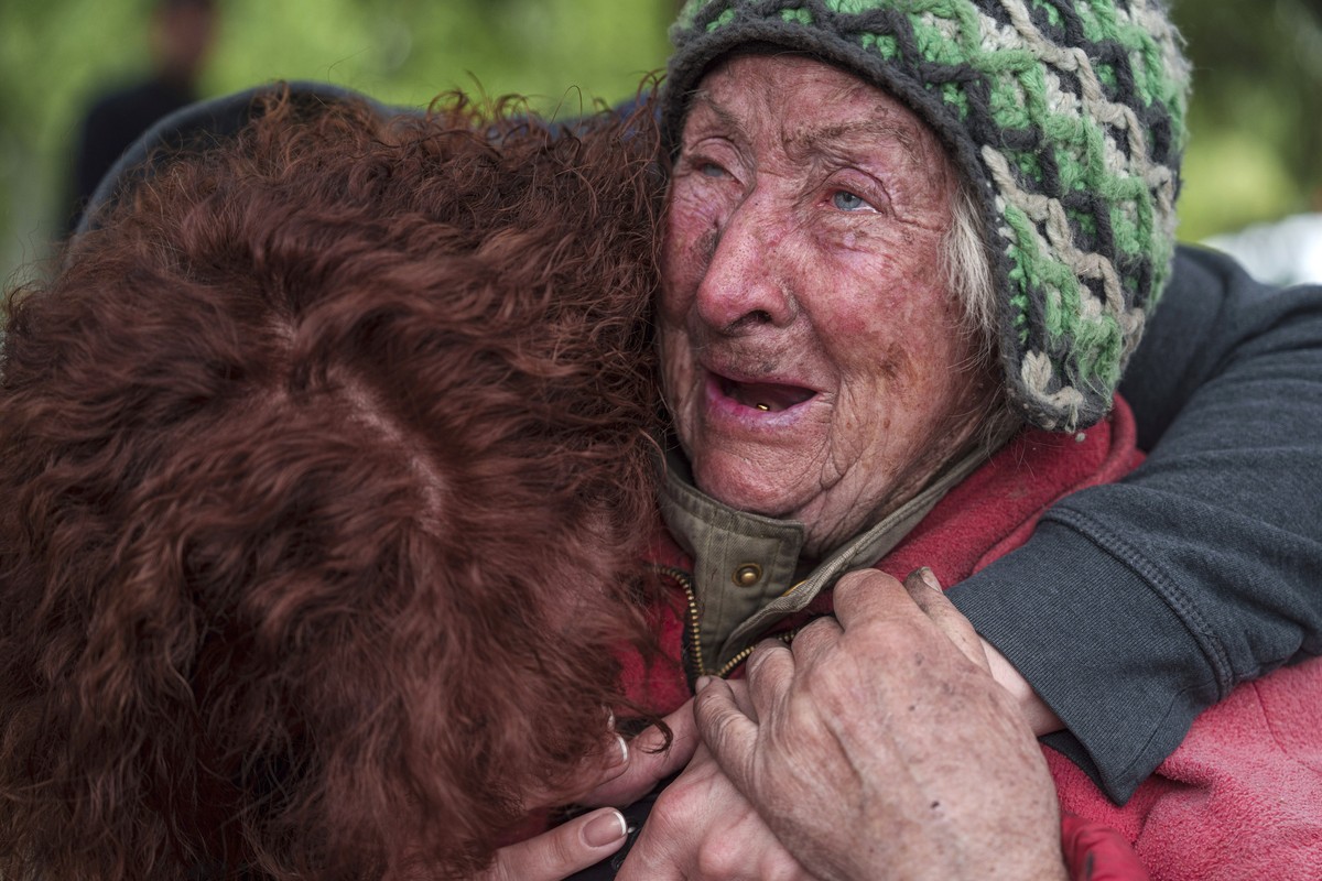 Tetiana, 82, cries with her daughter as she is evacuated from Vovchansk, Ukraine, Saturday, May 11, 2024. Her husband was killed in their house after a Russian airstrike on the city. (AP Photo/Evgeniy ...