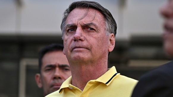 epa12305152 Former Brazilian president Jair Bolsonaro (R) leaves a branch of the DF Star hospital services in Brasilia, Brazil, 16 August 2025. Bolsonaro, who is under house arrest while being tried f ...