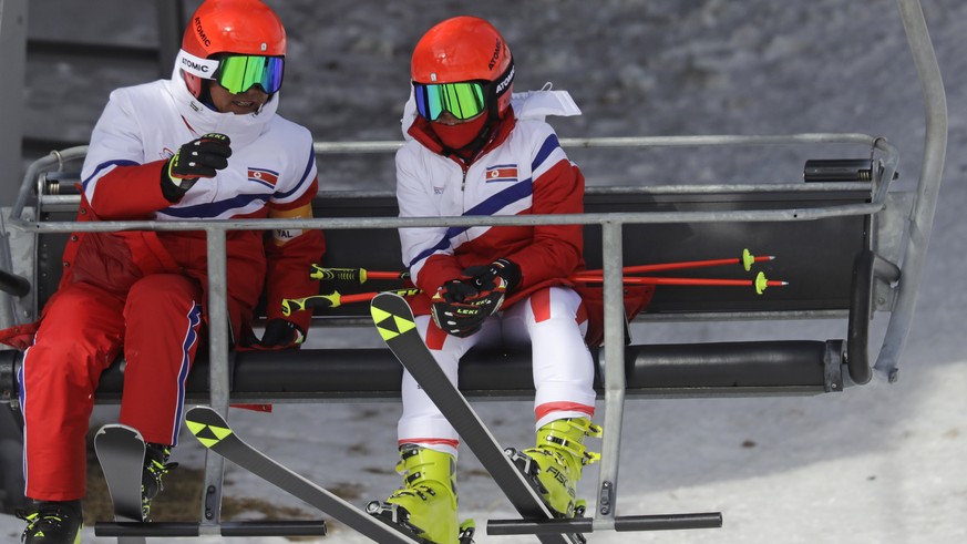 Kim Ryon Hyang of North Korea, right, takes a chair lift to participate in free skiing on the giant slalom course at the Yongpyong Alpine Center at the 2018 Winter Olympics in Pyeongchang, South Korea ...