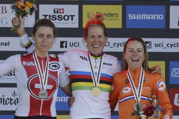 Netherlands&#039; Ellen Van Dijk, center, Marlen Reusser of Switzerland, left, and Annemiek van Vleuten of The Netherlands, right, celebrate on the podium after the Women Elite individual time trial r ...