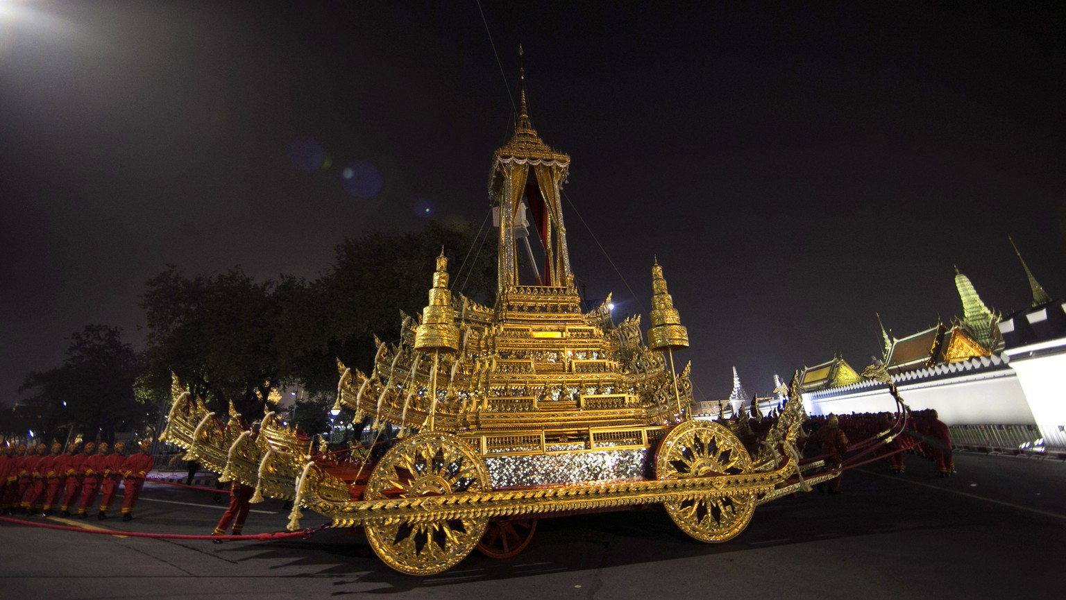 The royal officials pull to the royal chariot which will be used to carry the body and the royal urn of the late Thai King Bhumibol Adulyadej, before royal funeral past the Grand Palace during the Roy ...