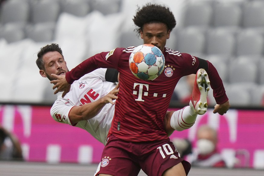 Bayern&#039;s Leroy Sane, right, and Cologne&#039;s Mark Uth vie for the ball during the German Bundesliga soccer match between Bayern Munich and Cologne in Munich, Germany, Sunday, Aug. 22, 2021. (AP ...