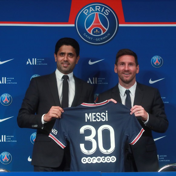 epa09409505 Paris Saint-Germain&#039;s president Nasser Al-Khelaifi and Argentinian striker Lionel Messi (R) pose with his new PSG jersey after his press conference as part of his official presentatio ...