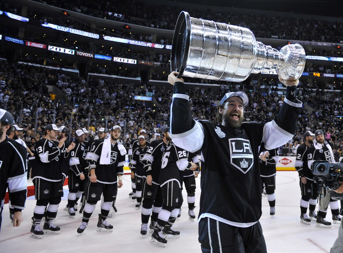 Jun 13, 2014; Los Angeles, CA, USA; Los Angeles Kings right wing Justin Williams hoists the Stanley Cup after defeating the New York Rangers game five of the 2014 Stanley Cup Final at Staples Center.  ...