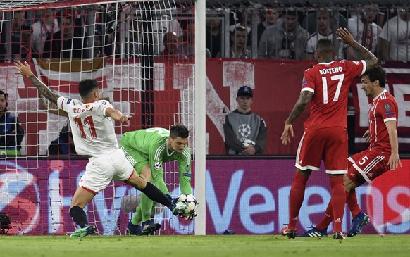 Bayern goalkeeper Sven Ulreich, makes a save ahead of Sevilla&#039;s Carlos Joaquin Correa during the Champions League quarter final second leg soccer match between FC Bayern Munich and Sevilla FC at  ...