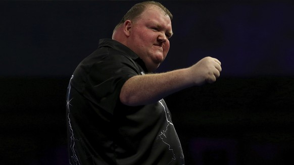 Britain&#039;s John Henderson celebrates winning his match during the walk on day ten of the World Darts Championship at Alexandra Palace, London, Saturday, Dec. 23, 2017. (Steven Paston/PA via AP)