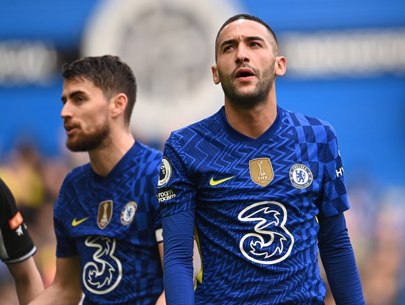 epa09821320 Jorginho (L) and Hakim Ziyech of Chelsea wear the their jersey with the logo of mobile company Three despite its suspension of shirt sponsorship during the English Premier League soccer ma ...