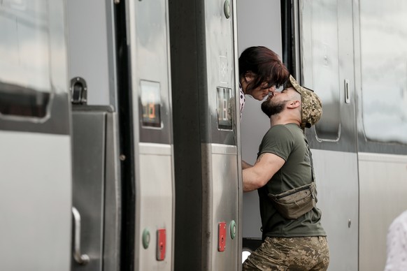 epa10660073 A couple bid each other farewell at the railway station in Kramatorsk, Donetsk region, Ukraine, 28 May 2023. Under martial law, Ukrainian servicemen are entitled to 10 days of vacation per ...