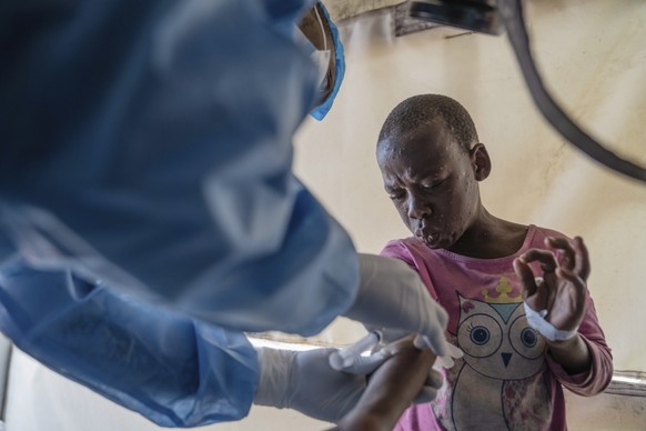 A health worker attends to a mpox patient, at a treatment centre in Munigi, eastern Congo, Monday, Aug. 19, 2024. Congo will receive the first vaccine doses to address its mpox outbreak next week from ...