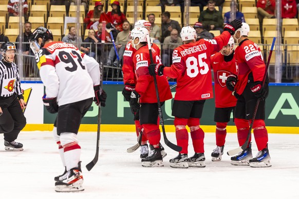 Switzerland's forward Kevin Fiala #21 celebrates his goal with his teammates after scoring the 4:0, during the IIHF 2025 World Championship quarter final game between Switzerland and Austria, at  ...
