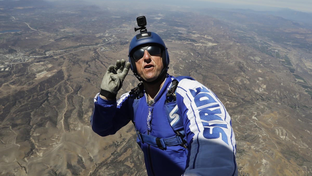 In this Monday, July 25, 2016 photo, skydiver Luke Aikins signals to pilot Aaron Fitzgerald as he prepares to jump from a helicopter in Simi Valley, Calif. After months of training, this elite skydive ...