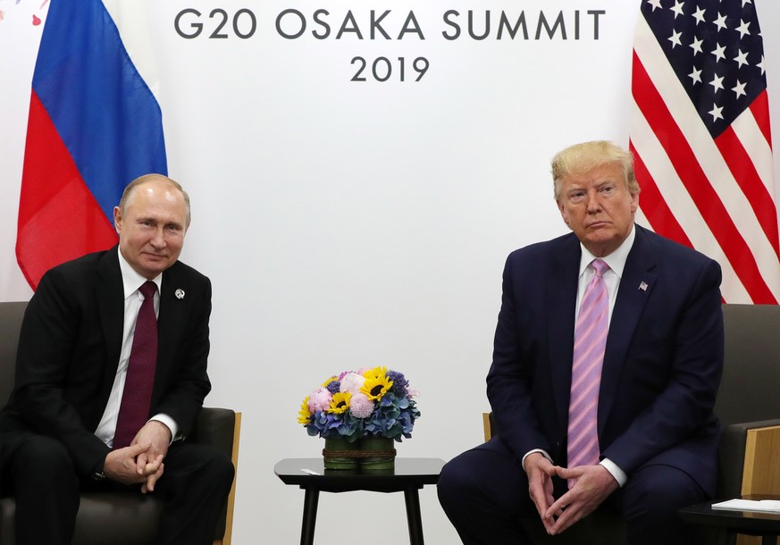 epa07753055 (FILE) - Russian President Vladimir Putin (L) and US President Donald J. Trump (R) meet on the sidelines of the G20 summit in Osaka, Japan, 28 June 2019 (reissued 02 August 2019). US forma ...