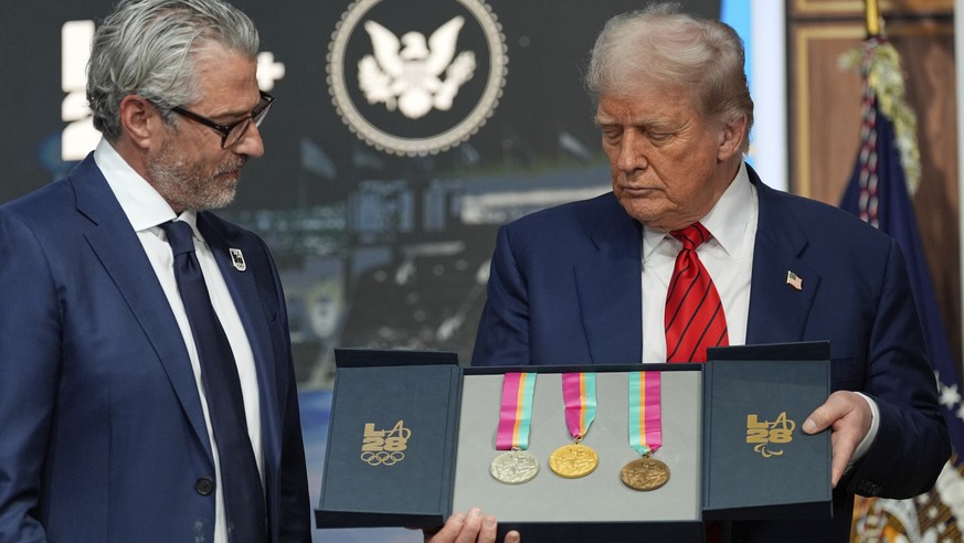 KEYPIX - President Donald Trump listens as Casey Wasserman, chairman of LA28, presents him a full set of medals from the 1984 Olympics in Los Angeles, during an event regarding the 2028 Los Angeles Ol ...