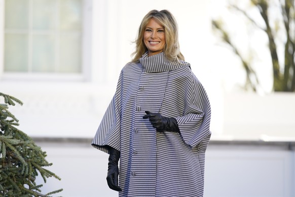 FILE - First lady Melania Trump stands next to the 2020 Official White House Christmas tree as it is presented on the North Portico of the White House, Monday, Nov. 23, 2020, in Washington. (AP Photo/ ...