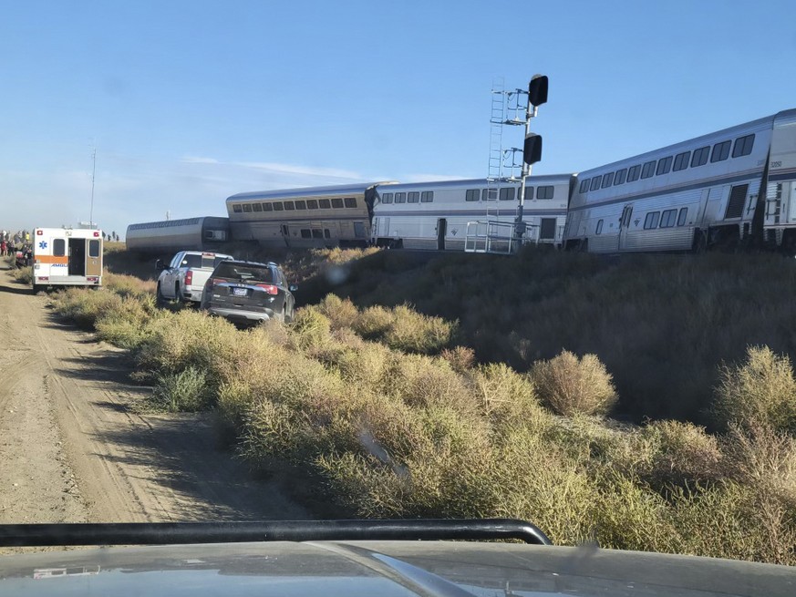 In this photo provided by Kimberly Fossen an ambulance is parked at the scene of an Amtrak train derailment on Saturday, Sept. 25, 2021, in north-central Montana. Multiple people were injured when the ...