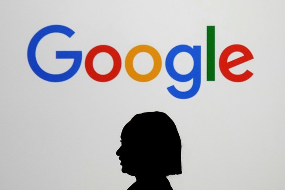 FILE - A woman walks by a giant screen displaying the Google logo at an event at the Paris Google Lab on the sidelines of the AI Action Summit in Paris, Feb. 9, 2025. (AP Photo/Thibault Camus, File)
A ...
