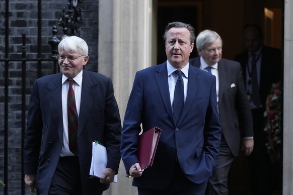 David Cameron, right, British Secretary of State for Foreign, Commonwealth and Development Affairs, with Andrew Mitchell, Secretary of State at the Foreign Office, leaves after a Cabinet meeting on...