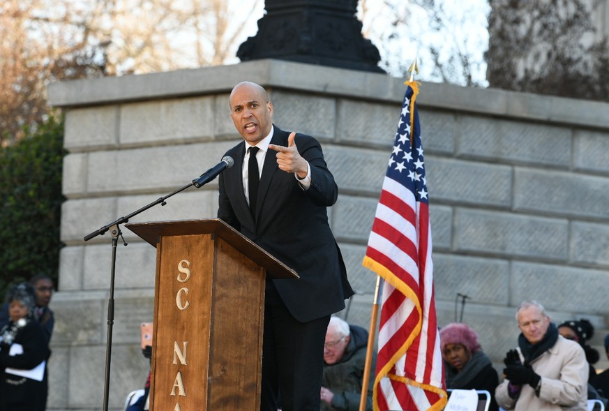 Sen. Cory Booker, D-N.J., speaks as Bernie Sanders, I-Vt., third from right, and others listen during Martin Luther King Jr. Day celebrations at the South Carolina Statehouse in Columbia, S.C., on Mon ...