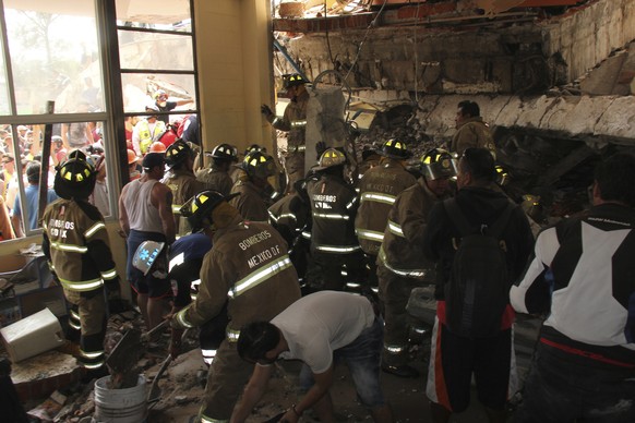 Rescue workers search for children trapped inside the collapsed Enrique Rebsamen school in Mexico City, Tuesday, Sept. 19, 2017. The earthquake stunned central Mexico, killing more than 100 people as  ...